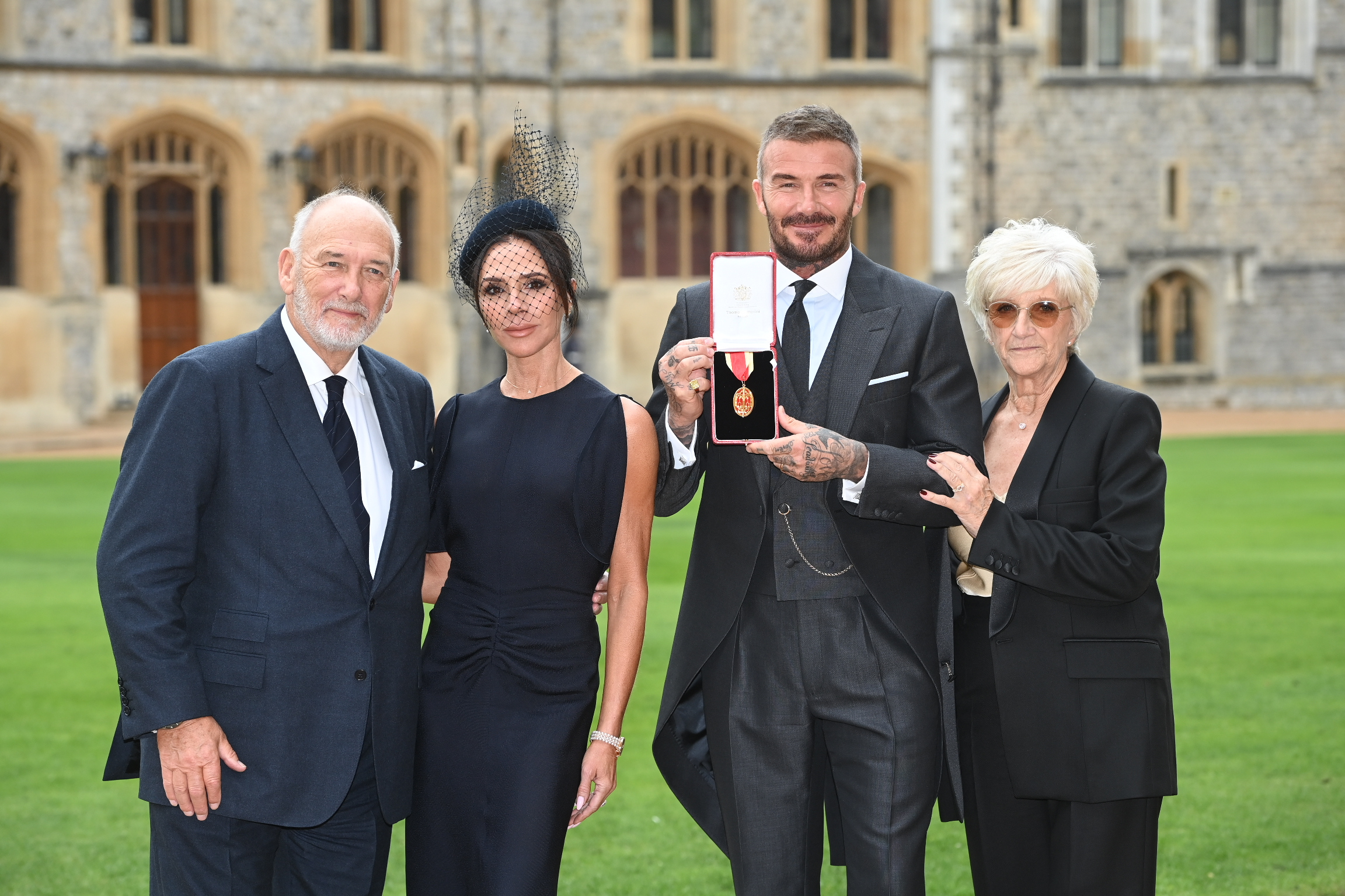 Sir David Beckham and his wife Victoria, along with parents Ted and Sandra, after receiving his knighthood at an Investiture at Windsor Castle.