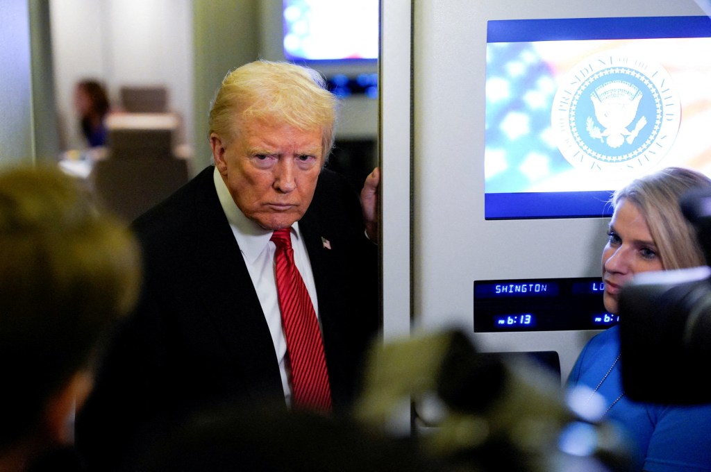 U.S. President Donald Trump speaks to members of the media on Air Force One.