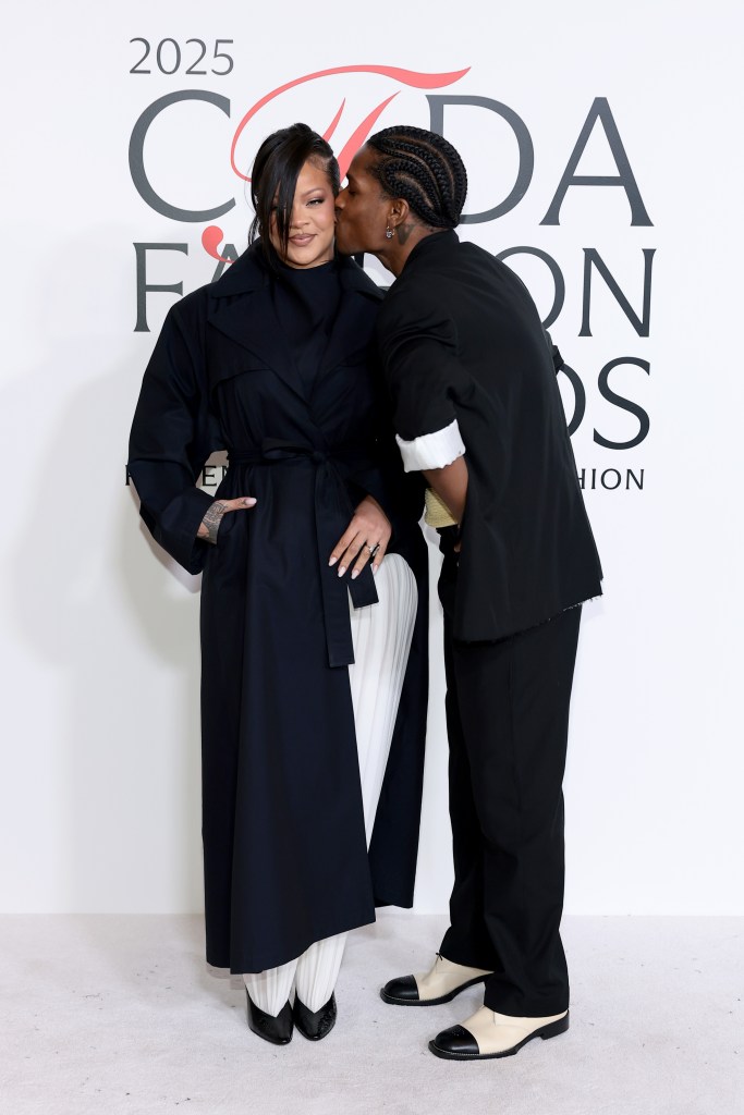 Rihanna gets a smooch by hubby A$AP Rocky while attending the 2025 CFDA Awards in NYC.