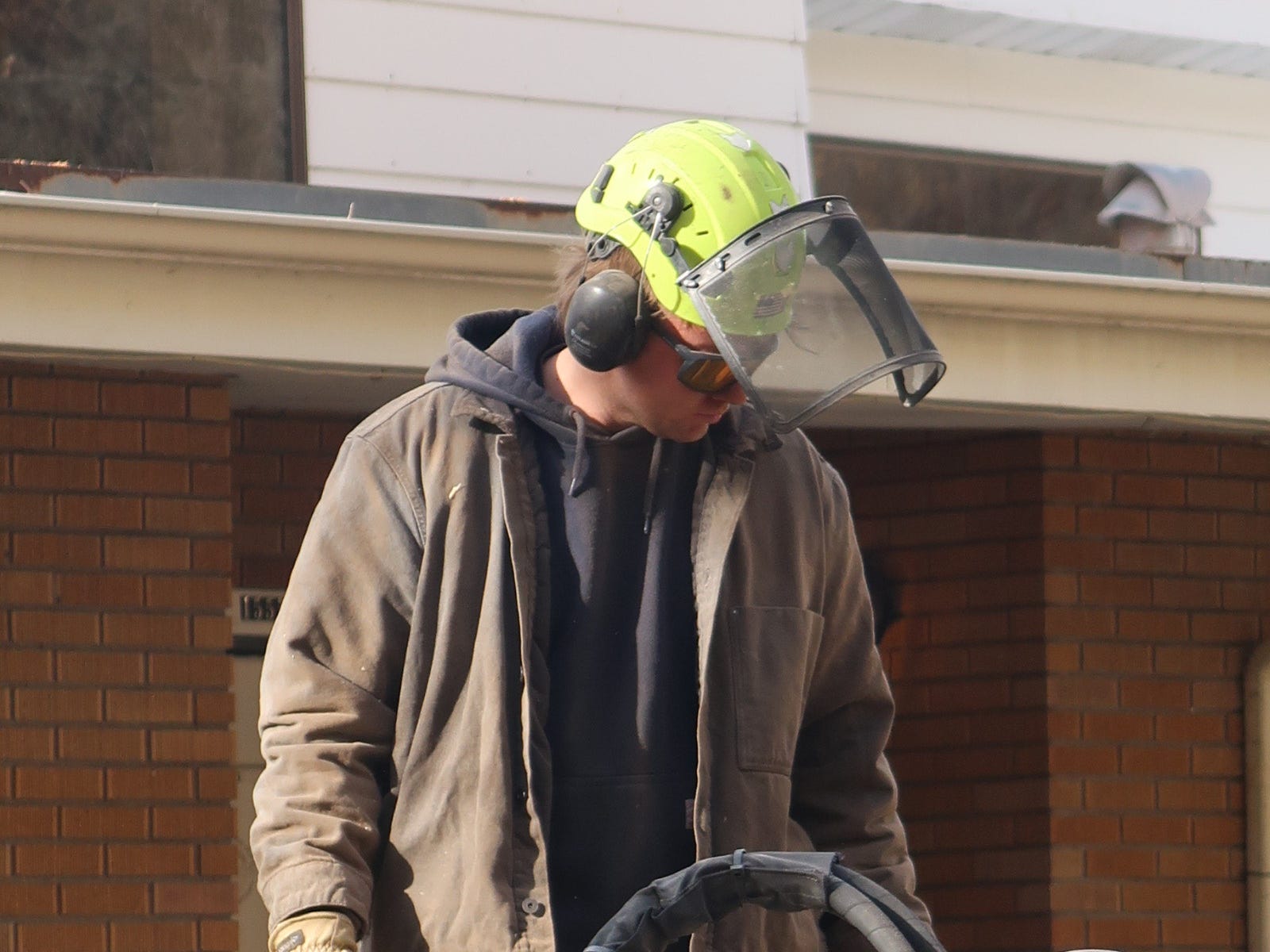 a man grinding a tree stump
