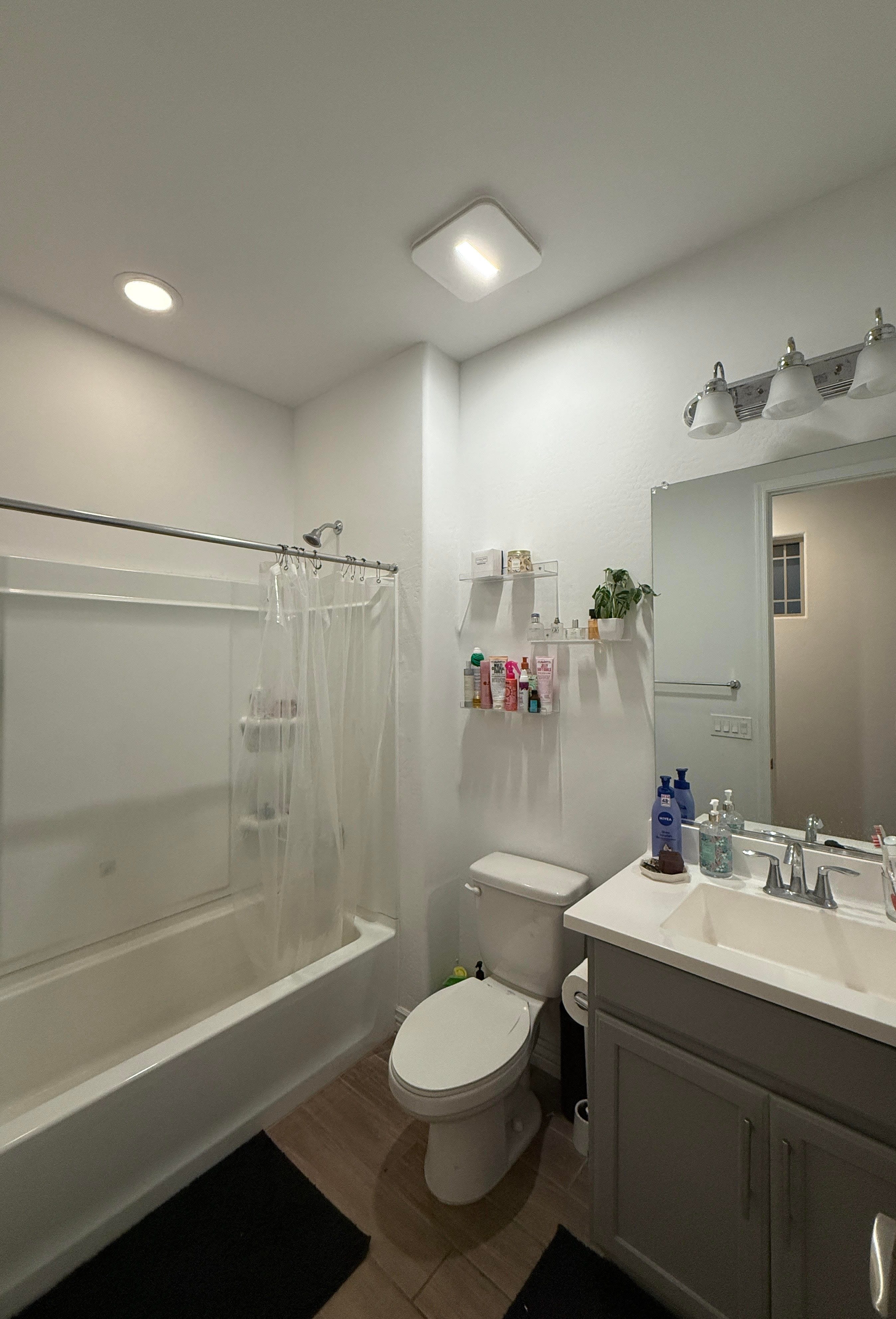 A bathroom with a bathtub, toilet, and sink.
