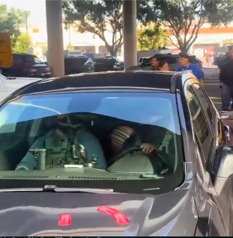 With the father detained, and the ball still in the child's face, the ICE officers drive away with the toddler as onlookers scream out.
