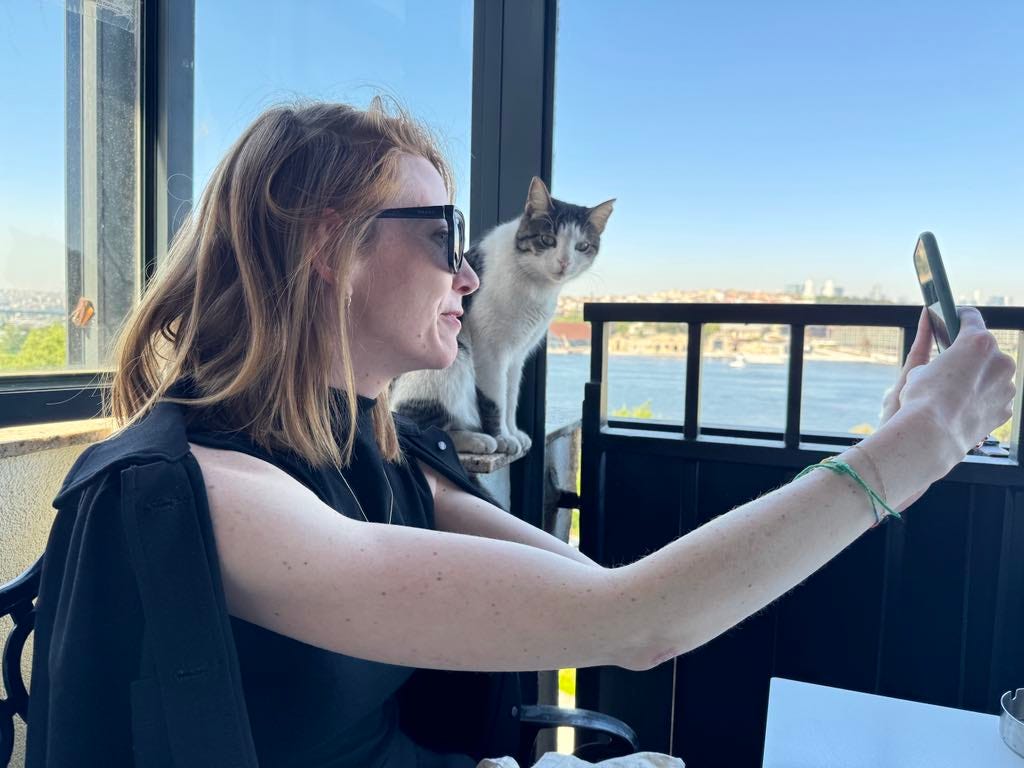 Kaitlyn takes a selfie with a cat.