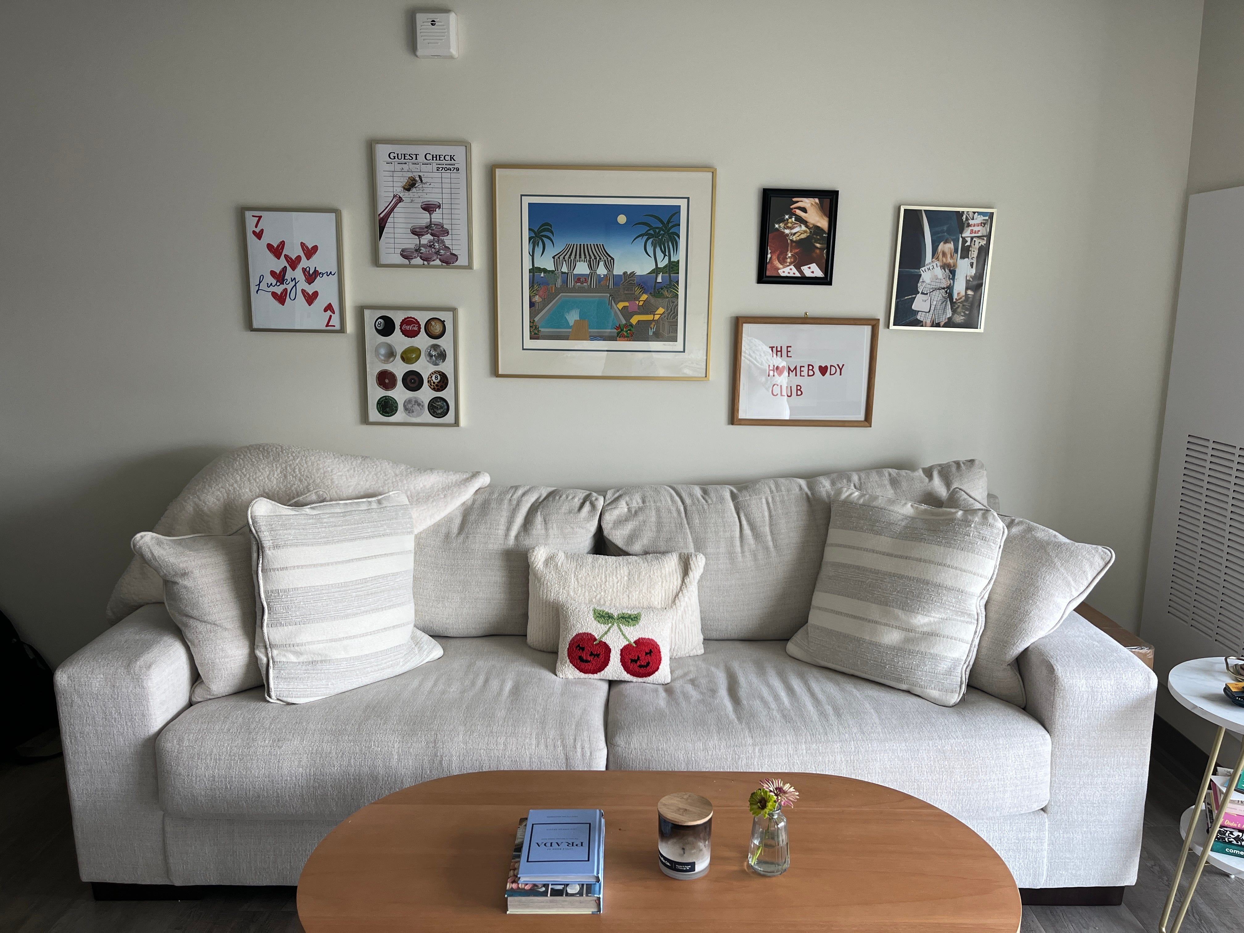 The author's living room setup, complete with a couch, coffee table, and gallery wall.