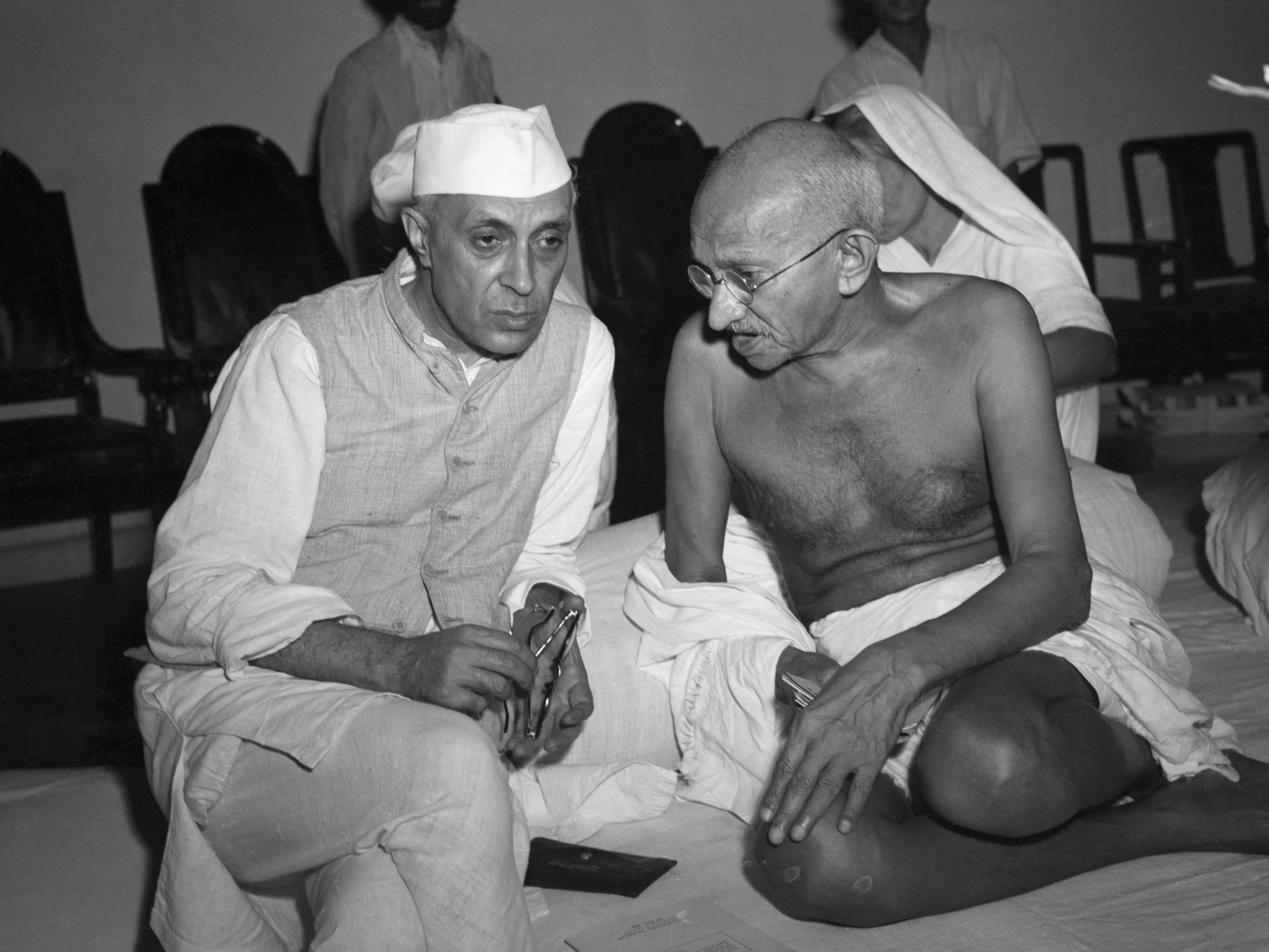 India's first prime minister, Jawaharlal Nehru, speaks with the architect of Indian independence, Mahatma Gandhi.