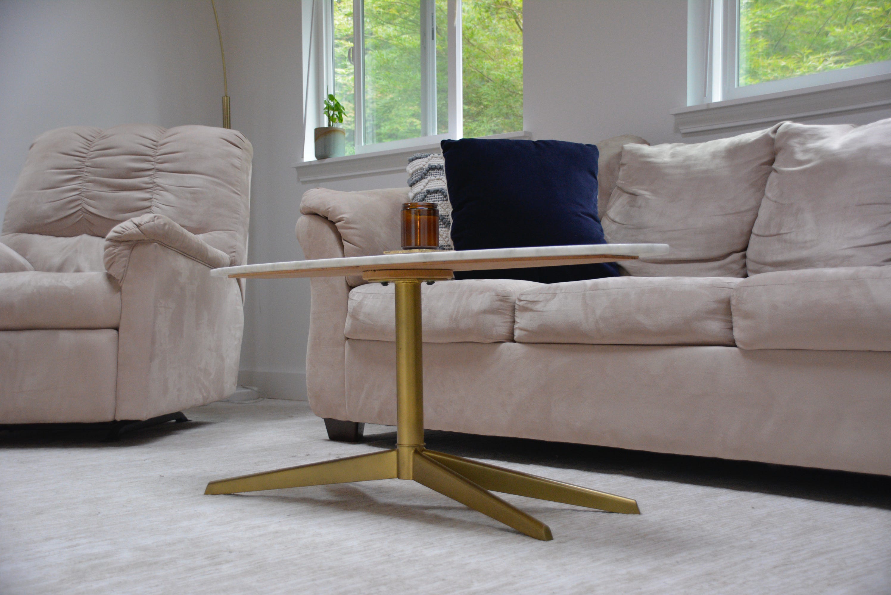 Gold table legs on marble coffee table