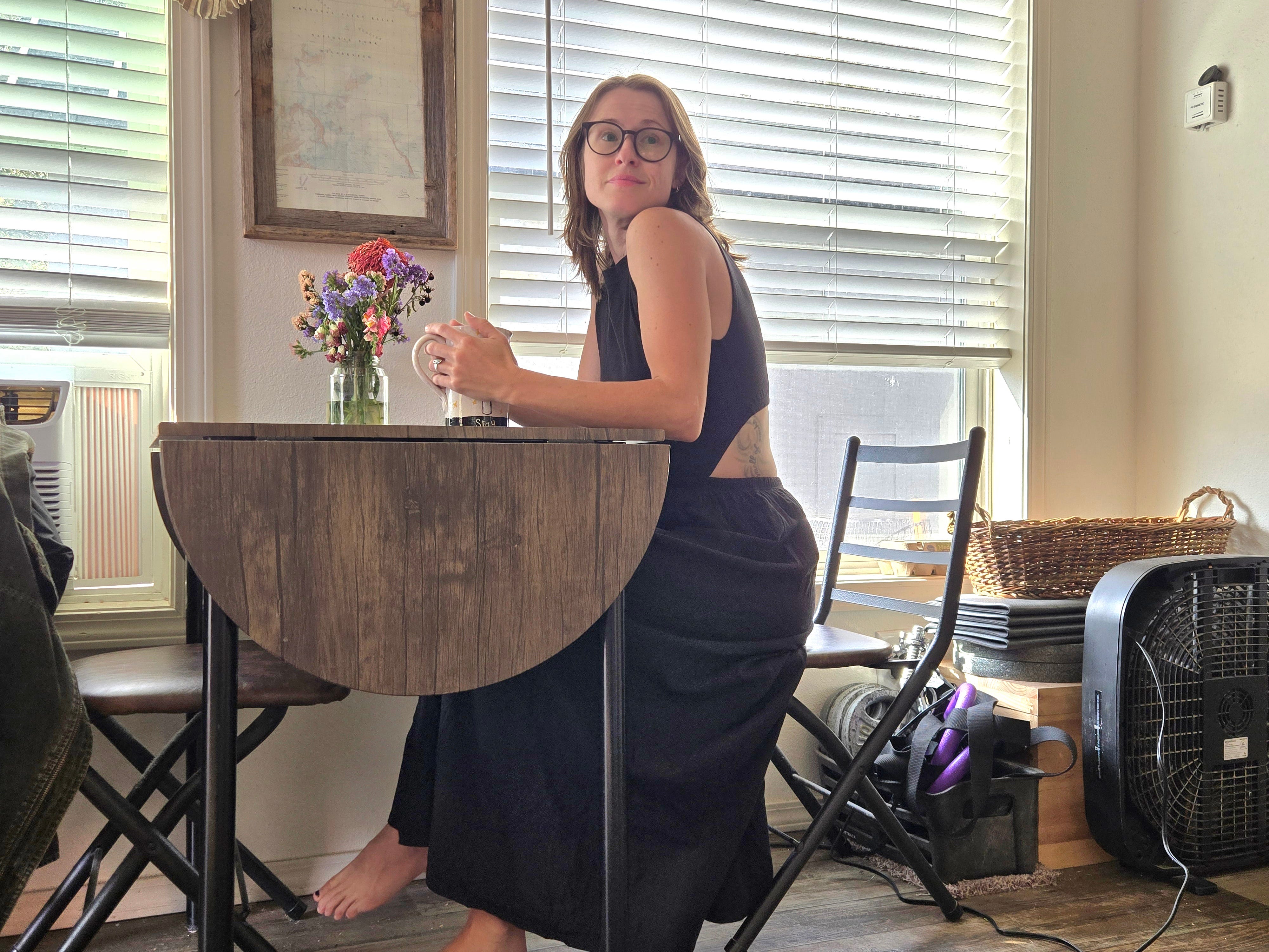 Author Amber McDaniel sitting at small table