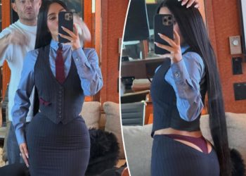 Kim Kardashian’s plunging ‘All’s Fair’ skirt suit lets her thong play peekaboo