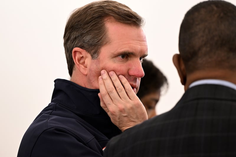 Kentucky Gov. Andy Beshear attends an emergency meeting to prepare for a press conference at Louisville Metro Hall.