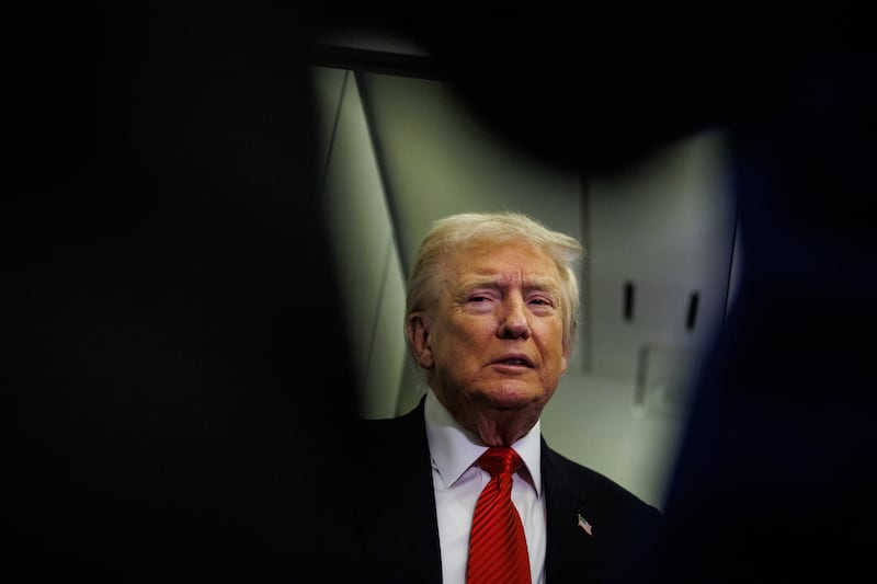 U.S. President Donald Trump speaks to reporters aboard Air Force One en route to the White House on November 2, 2025 after taking off from Palm Beach International Airport in West Palm Beach, Florida.
