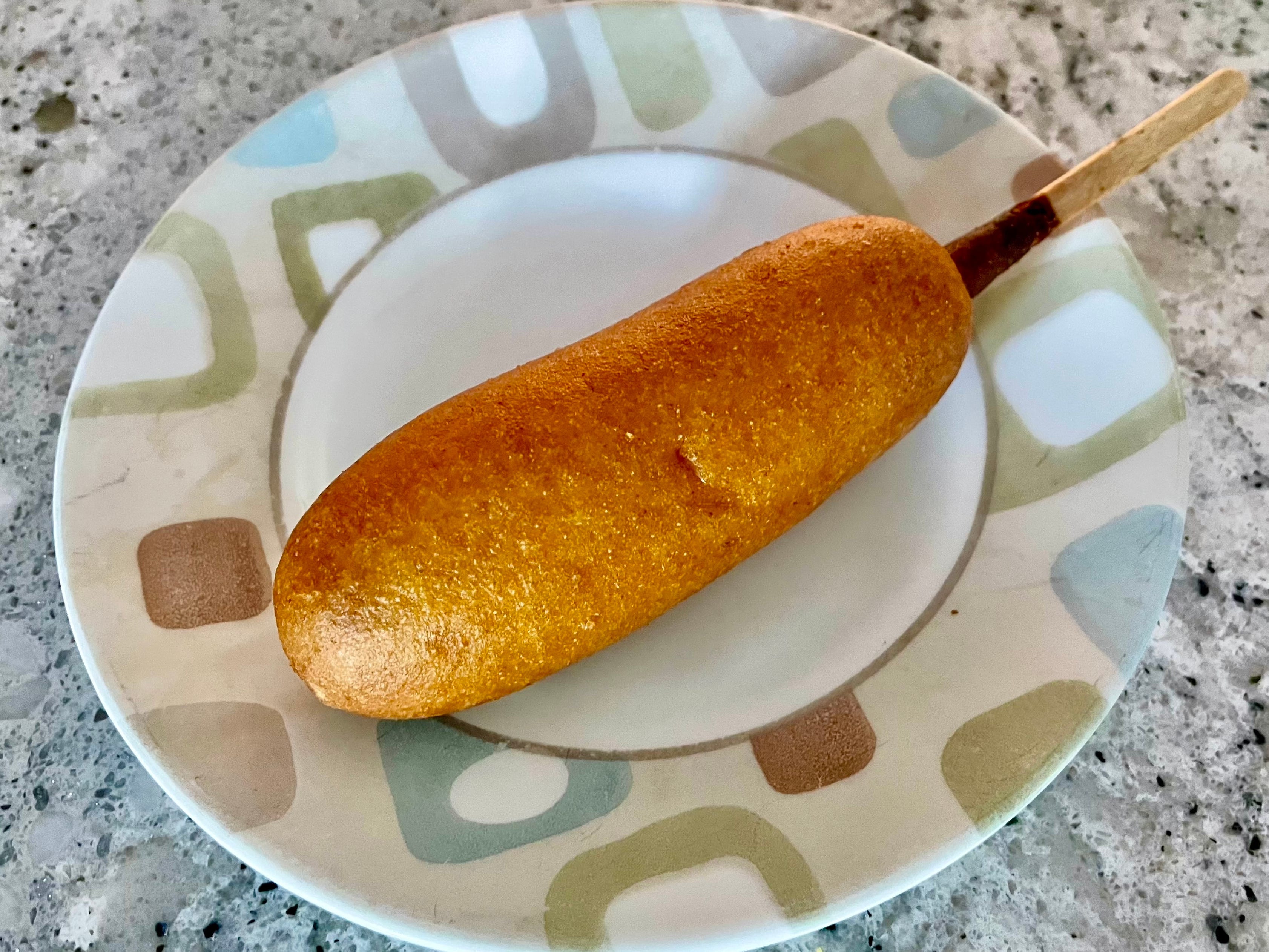 A State Fair classic corn dog on a plate.