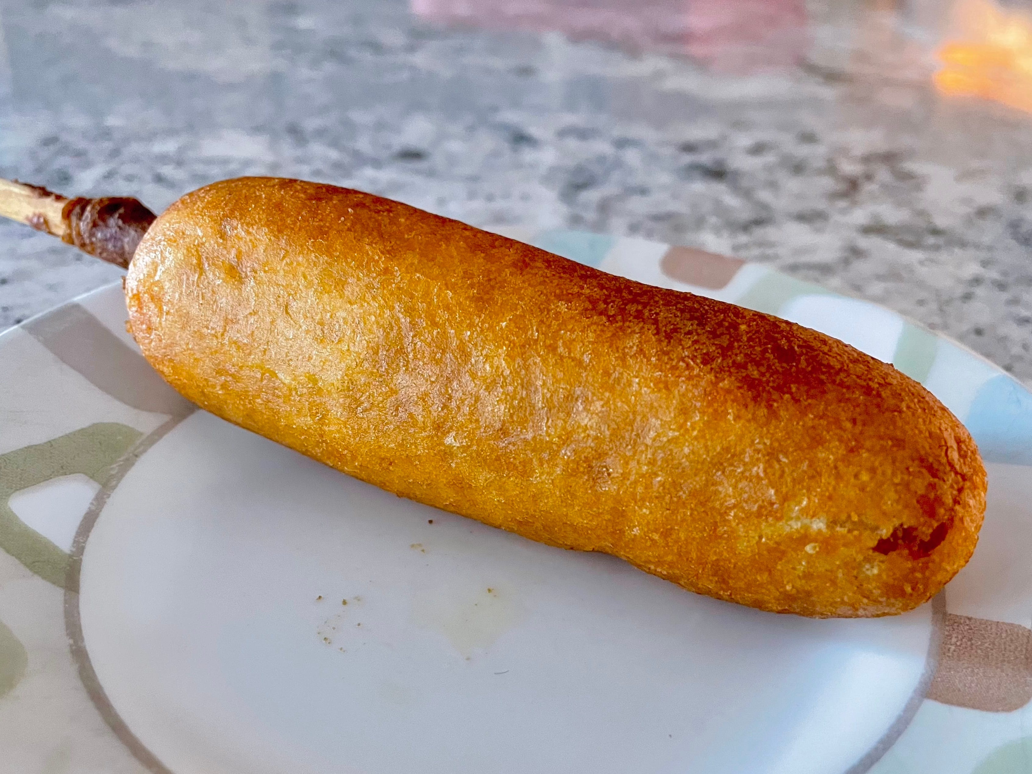 A Market Pantry corn dog on a plate.