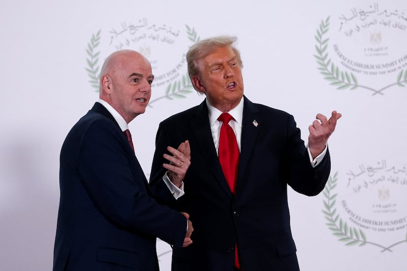 U.S. President Donald Trump and FIFA president Gianni Infantino pose for a photo, at a world leaders' summit on ending the Gaza war