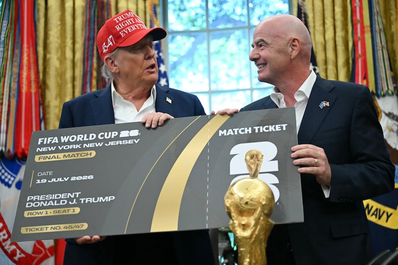 FIFA president Gianni Infantino (R) presents US President Donald Trump a FIFA world Cup ticket for the final match in the Oval Office.