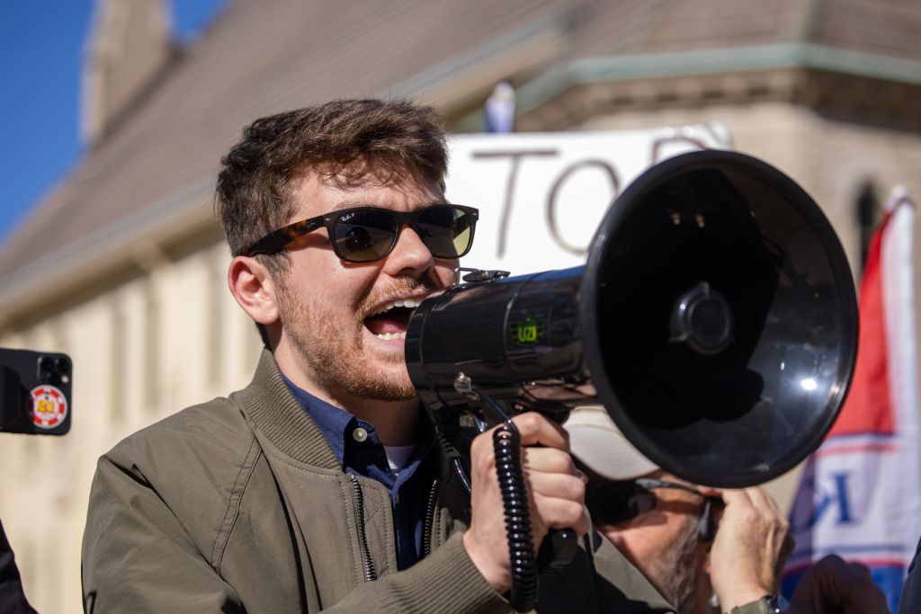 Nick Fuentes speaking into a megaphone at a 'Stop the Steal' protest.