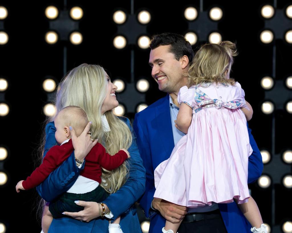 Charlie and Erika Kirk with their two children on stage.