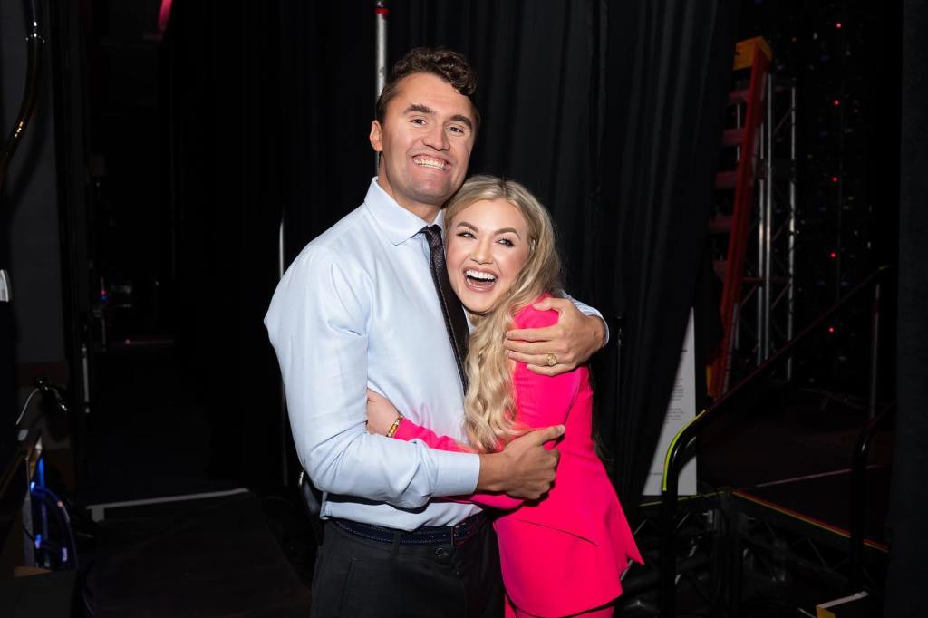Charlie and Erika Kirk hugging and smiling.