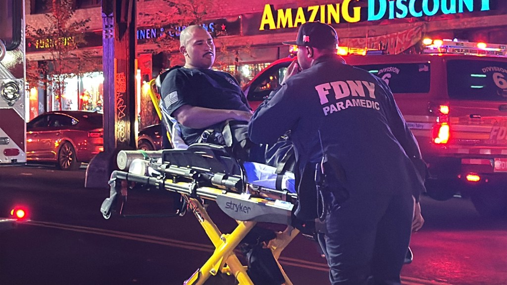 FDNY Paramedic attending to an injured person on a stretcher.