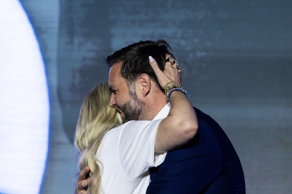 Vice President JD Vance embraces Erika Kirk on stage during a Turning Point USA event in Mississippi on Oct. 29, 2025.