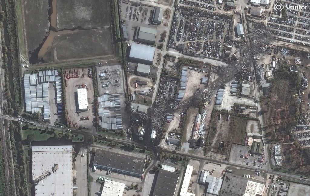 Satellite image showing debris from a cargo plane crash extending across industrial buildings and a junkyard near Louisville International Airport.