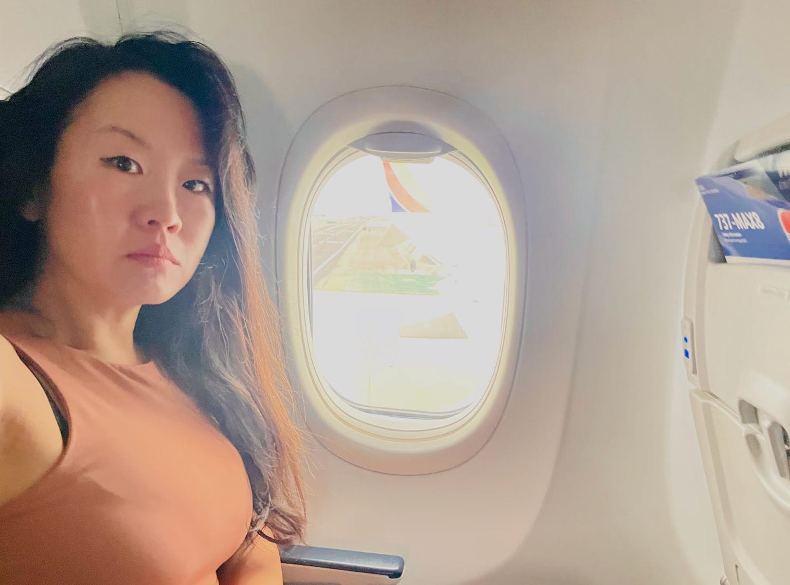 The writer posing on an airplane.