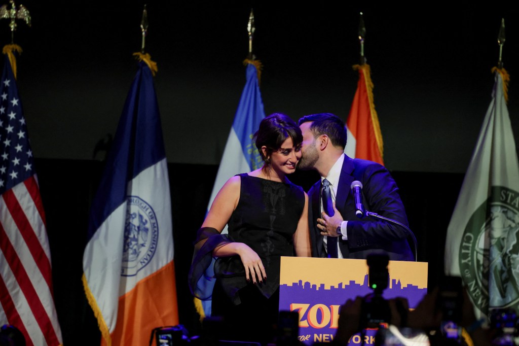 Zohran Mamdani kisses his wife Rama Duwaji at an election night rally.