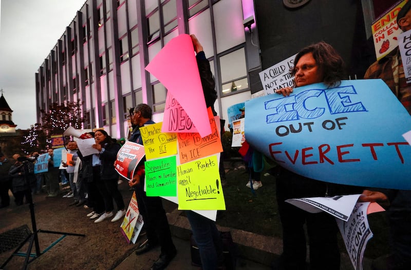Demonstrators protest during a rally outside Everett City Hall prior to a City Council meeting on October 14, 2025.