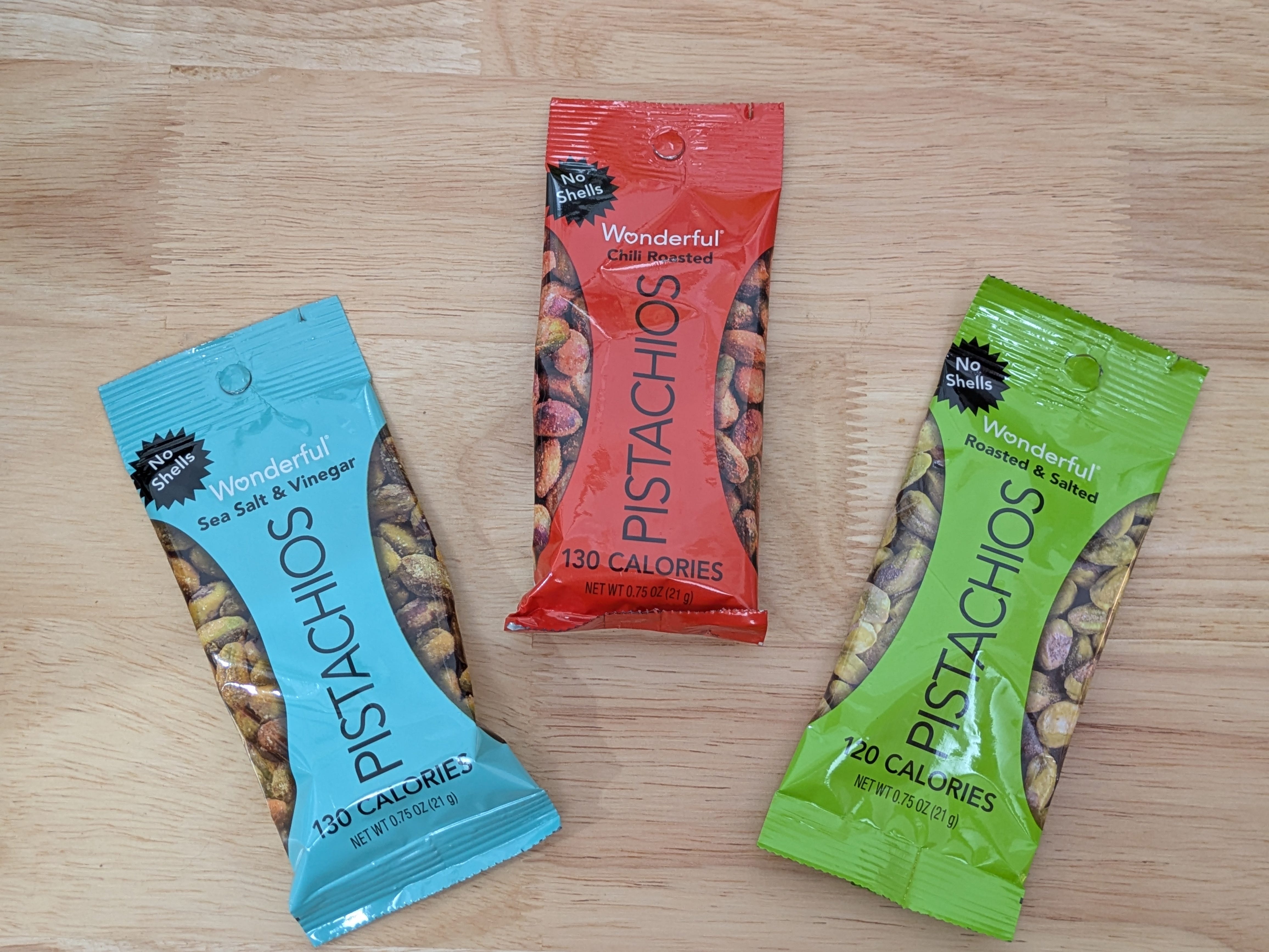 Three bags of Wonderful pistachios, in different flavors.