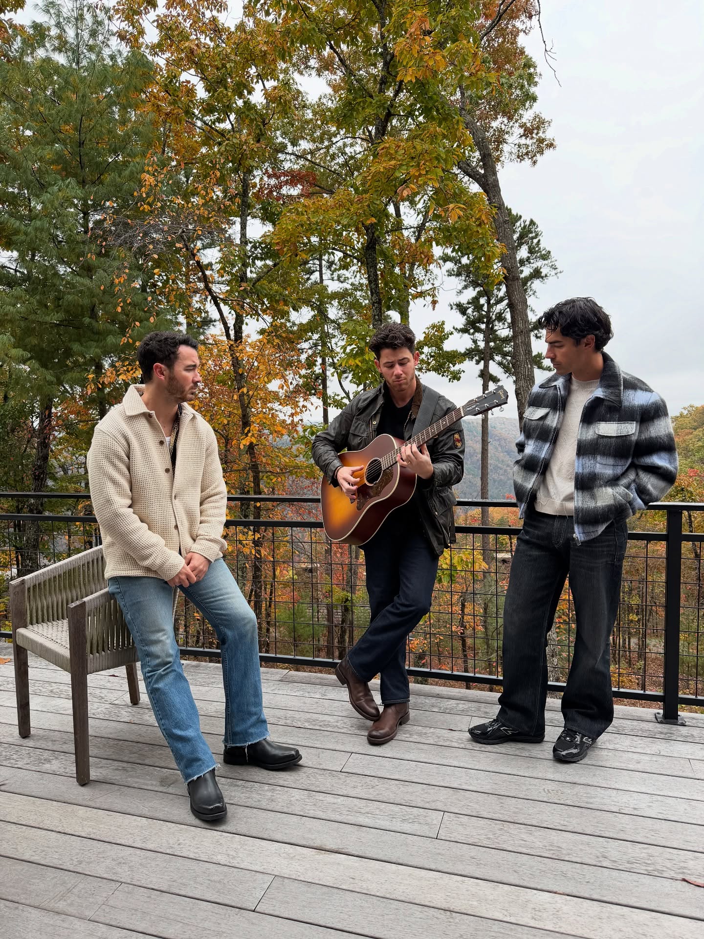 The Jonas Brothers play a tune surrounded by nature.