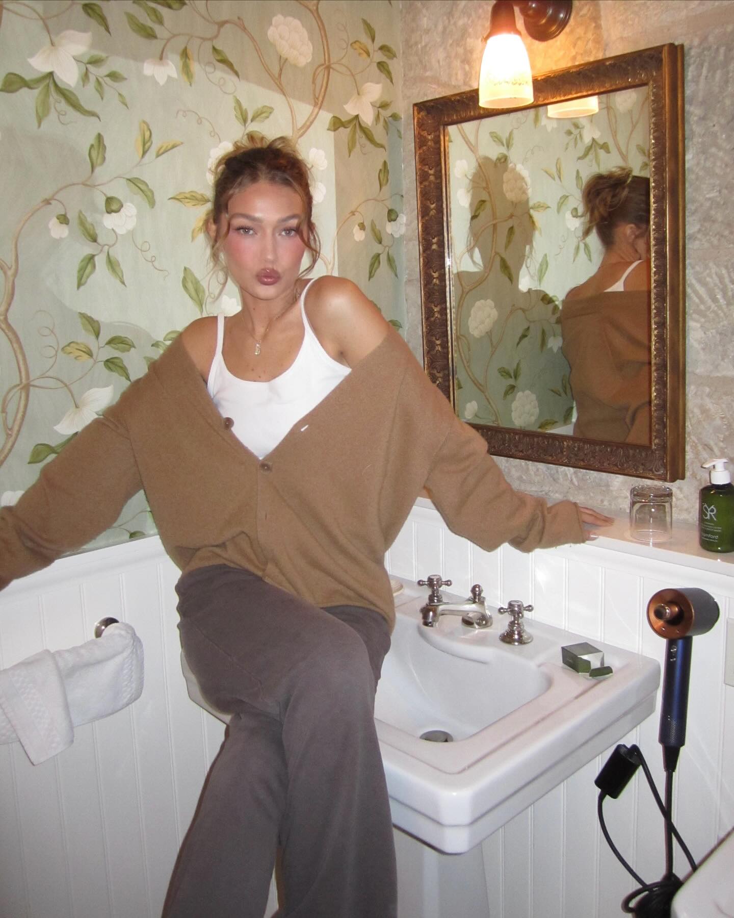 Gigi Hadid puckers up while lounging on a sink.