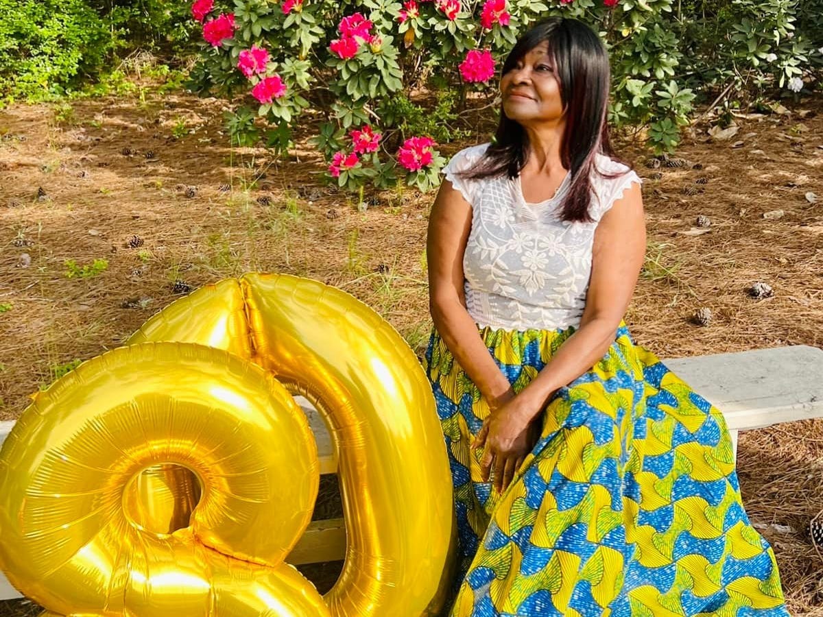 Janelle Jones' grandmother sitting next to balloons