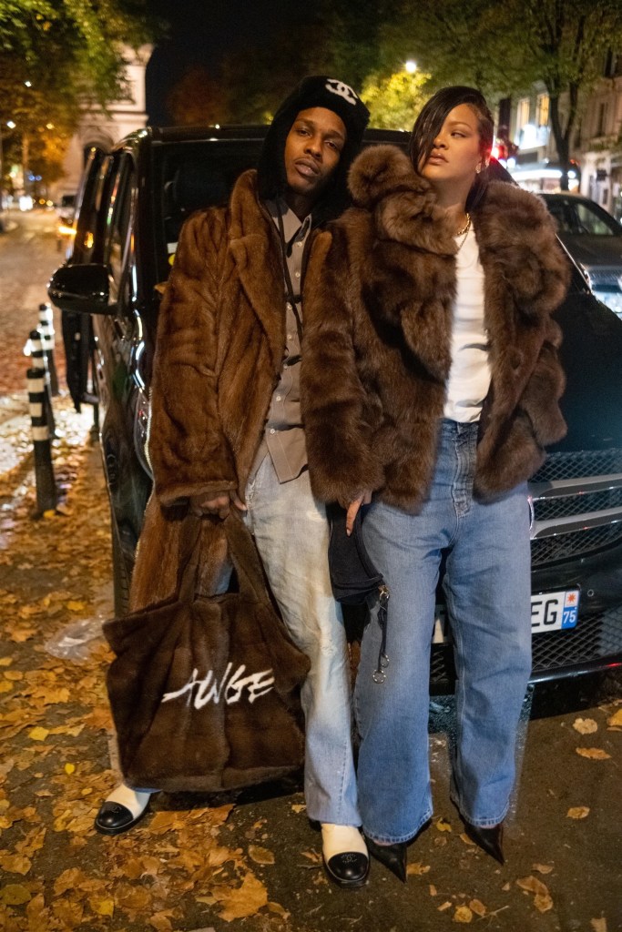 A$AP Rocky and Rihanna pose in brown fur coats and jeans in Paris.