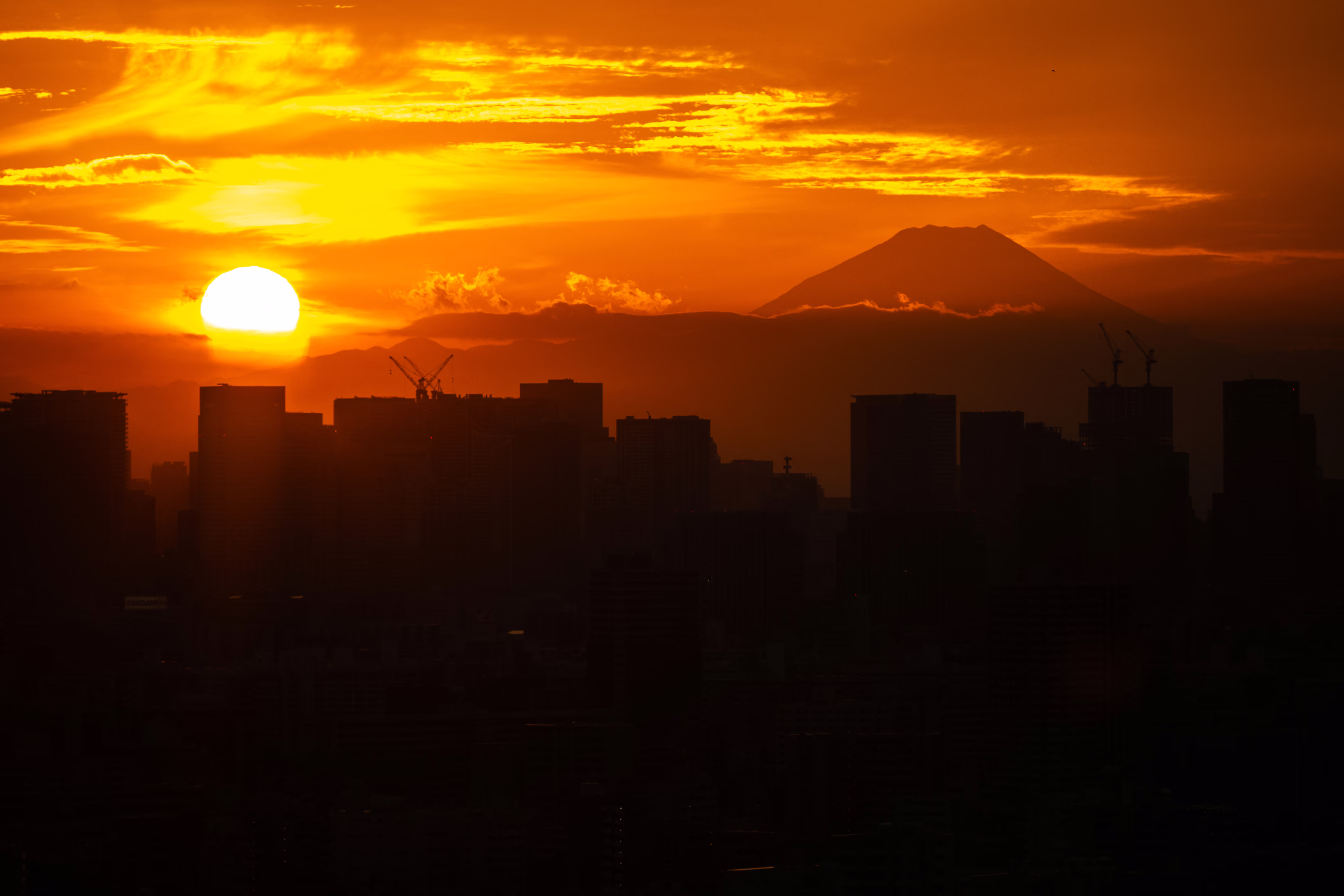 A sunset, seen from Tokyo, with Mount Fuji in the distance.