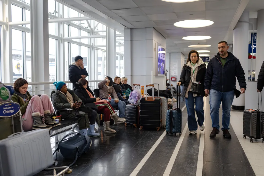 Travelers make their way through Terminal 5 after a winter snow storm affected the area at O'Hare International airport on November 30, 2025 in Chicago, Illinois.