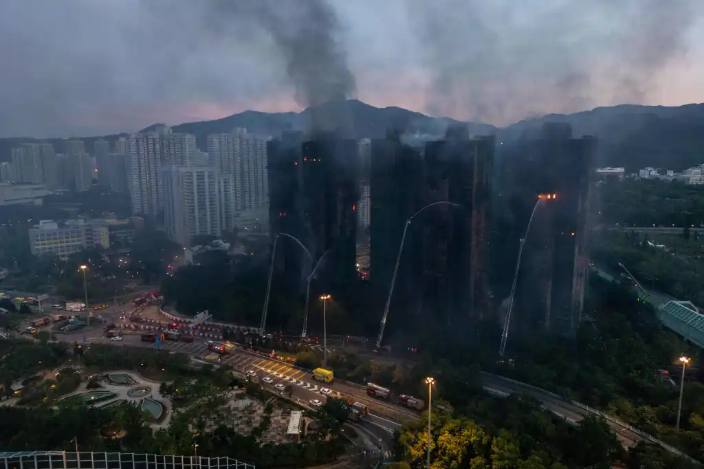 Smoke rises from the residential buildings as firefighters battle the deadly blaze on Nov. 27, 2025.