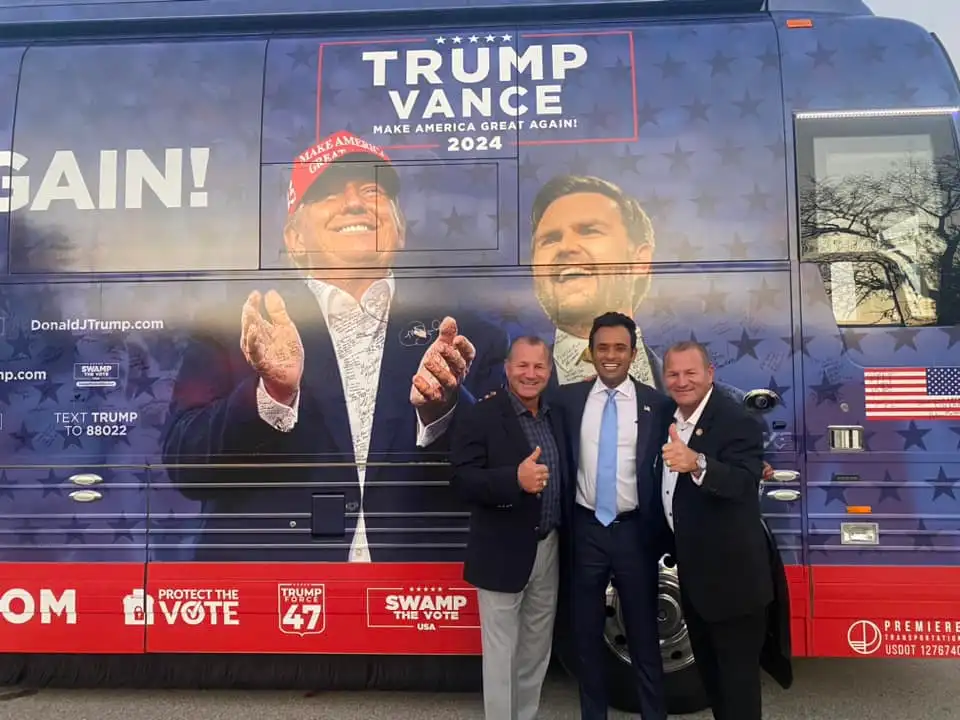 Rep. Troy Nehls poses for a photo with Vivek Ramaswamy and Trever Nehls in front of the Trump-Vance campaign bus in Wisconsin.
