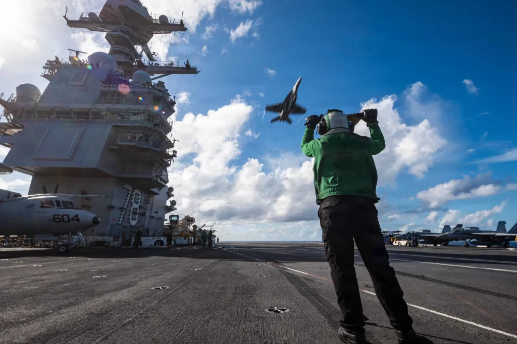A U.S. Sailor aboard the world's largest aircraft carrier, Ford-class aircraft carrier USS Gerald R. Ford (CVN 78), mans an advanced arresting gear push bar on the flight deck during flight operations, Nov. 17, 2025.