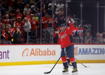 Alex Ovechkin becomes first NHL player to reach 900 goals as opposing goalie tries to hide milestone puck