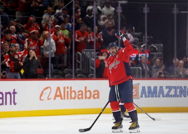 Alex Ovechkin becomes first NHL player to reach 900 goals as opposing goalie tries to hide milestone puck