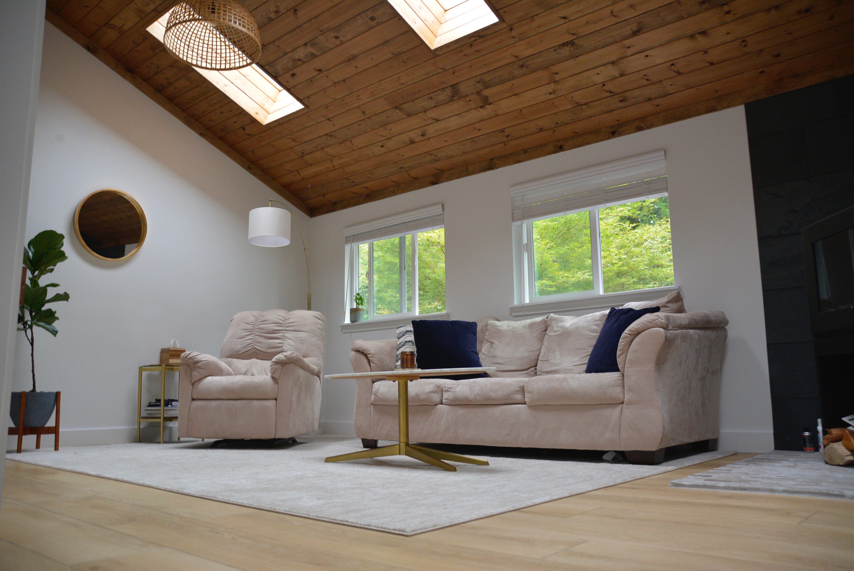 Beige couches under wood-paneled ceilings