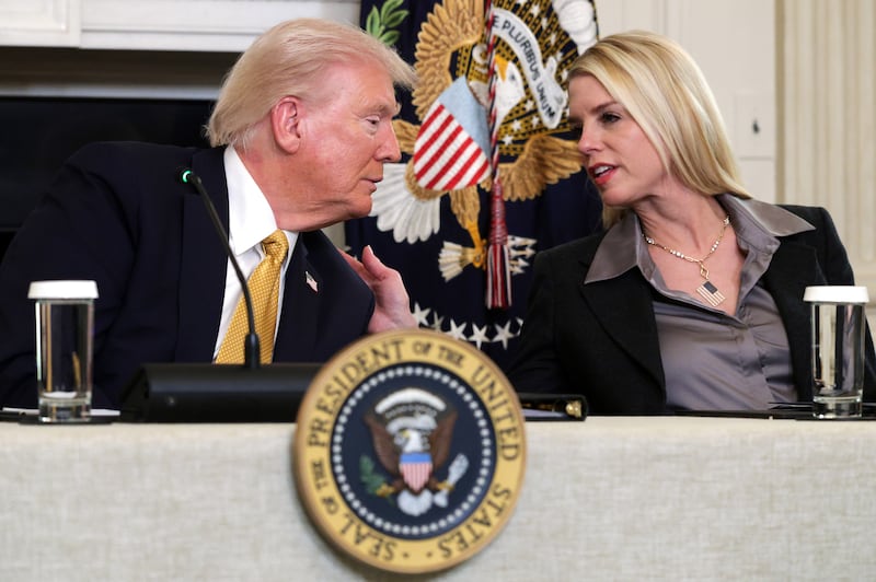 President Donald Trump speaks with Attorney General Pam Bondi in the State Dining Room of the White House on October 23, 2025, in Washington, DC.