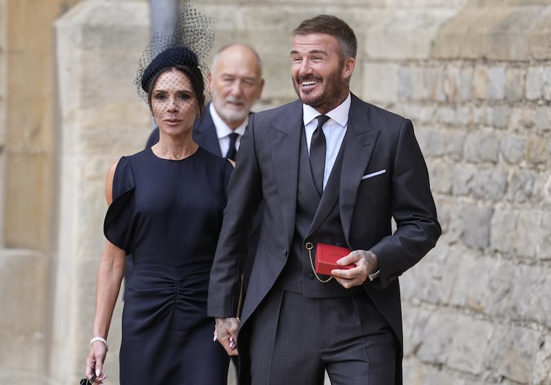 Sir David Beckham walks with his wife Lady Victoria after he was made a Knight Bachelor