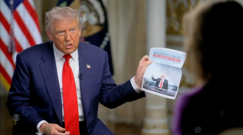 Trump brandishes his list of "resolved" conflicts.