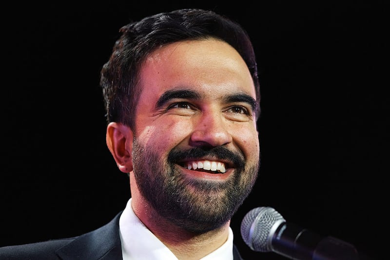 New York Mayoral Candidate Zohran Mamdani reacts during an election rally with Sen. Bernie Sanders (I-VT) and U.S. Rep. Alexandria Ocasio-Cortez (D-NY) at Forest Hills Stadium on October 26, 2025 in the Queens borough of New York City.