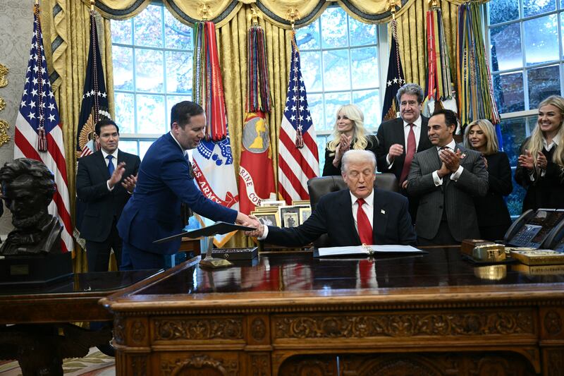 US President Donald Trump shakes hands with the newly appointed Ambassador to India Sergio Gor during a swearing-in ceremony in the Oval Office of the White on November 10, 2025 in Washington, DC. (Photo by Brendan SMIALOWSKI / AFP) (Photo by BRENDAN SMIALOWSKI/AFP via Getty Images)