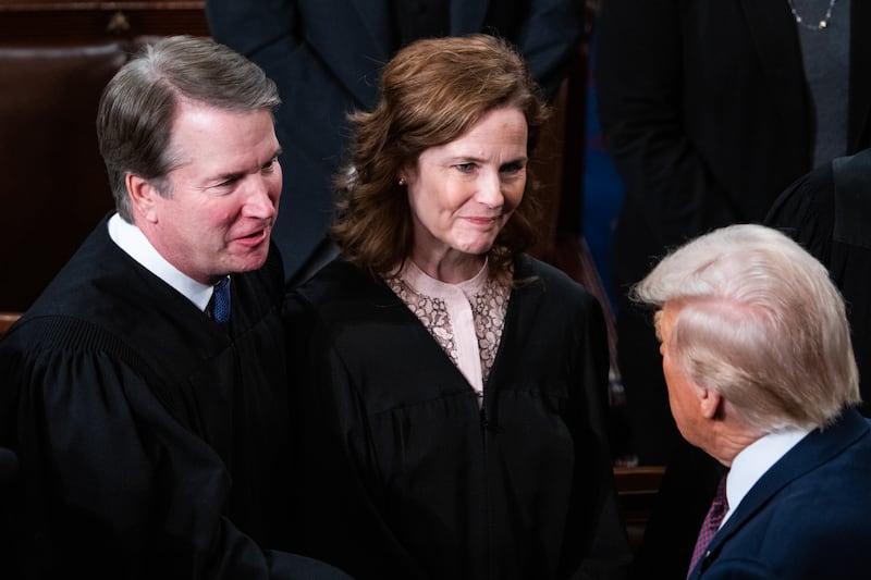 Supreme Court Justices Brett Kavanaugh and Amy Coney Barrett greet President Donald Trump after his address to a joint session of Congress in the House Chamber of the U.S. Capitol on Tuesday, March 4, 2025.