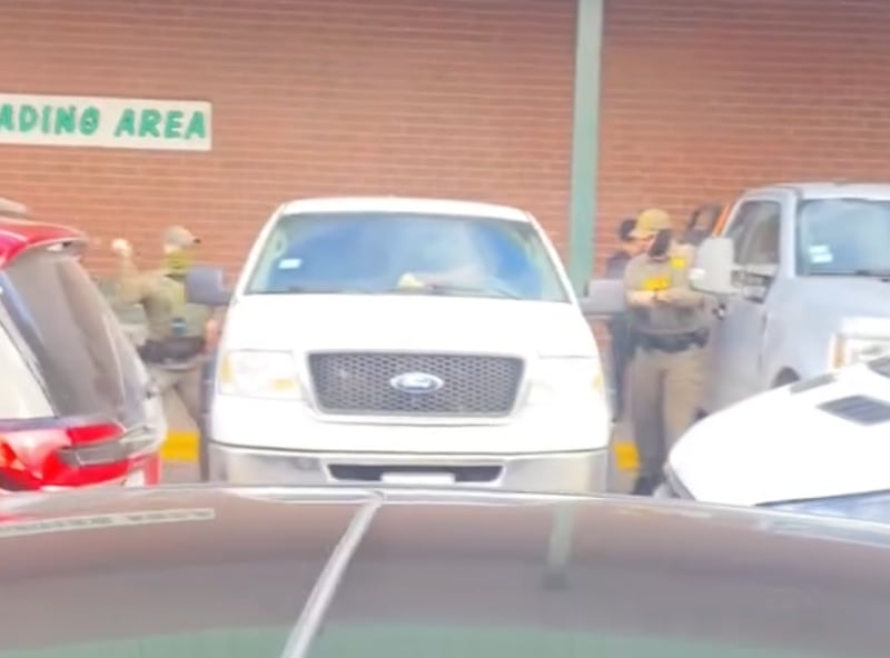 Border Patrol officer smashes the window of a car during the detention of a man. After Menards' security guard Ricardo Mendez filmed it, he was fired.