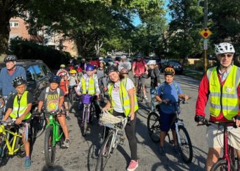 From a few to more than 350, children and parents ride together to school as a ‘bike bus’