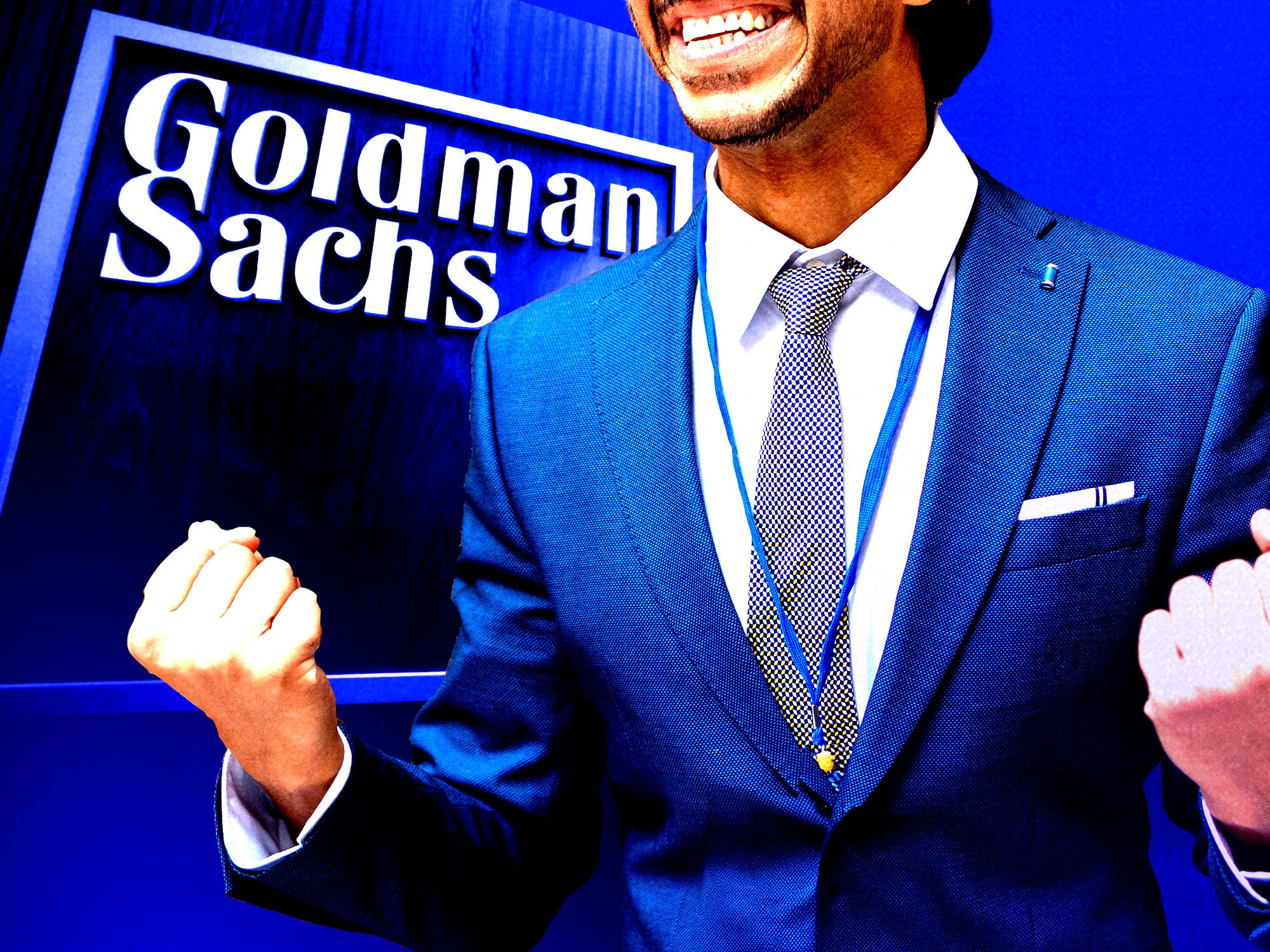 Excited businessman in front of the Goldman Sachs logo.