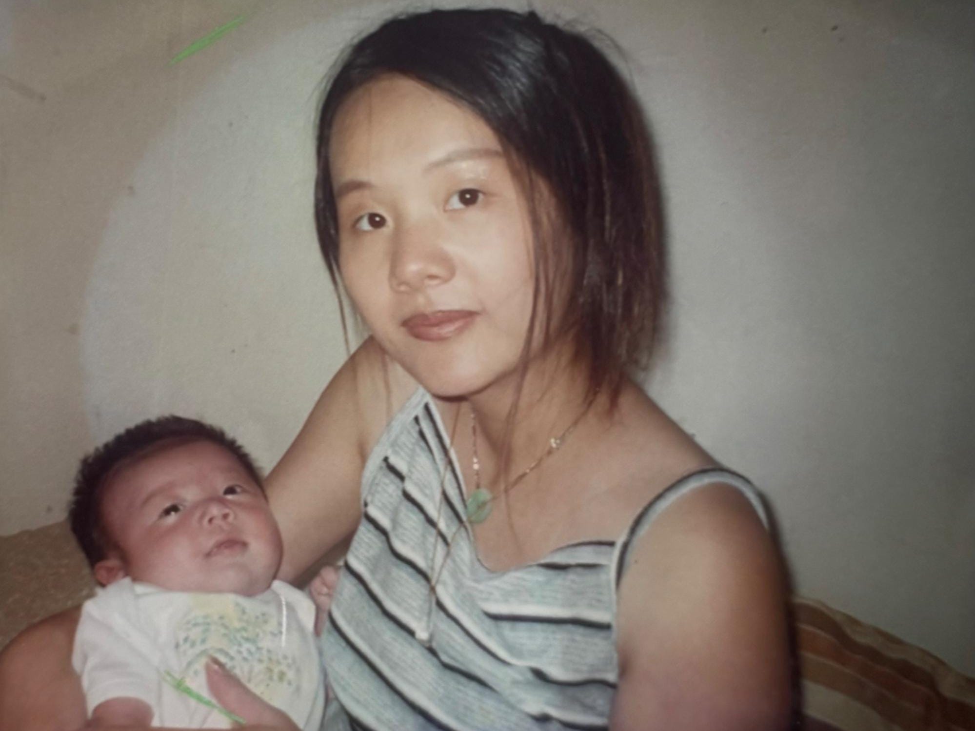 Brian Zhang as a baby being held by his mom